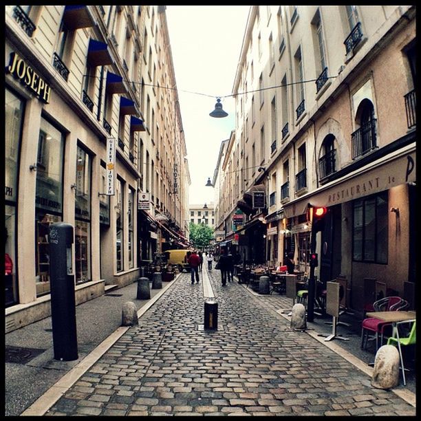 NARROW ALLEY WITH BUILDINGS IN BACKGROUND