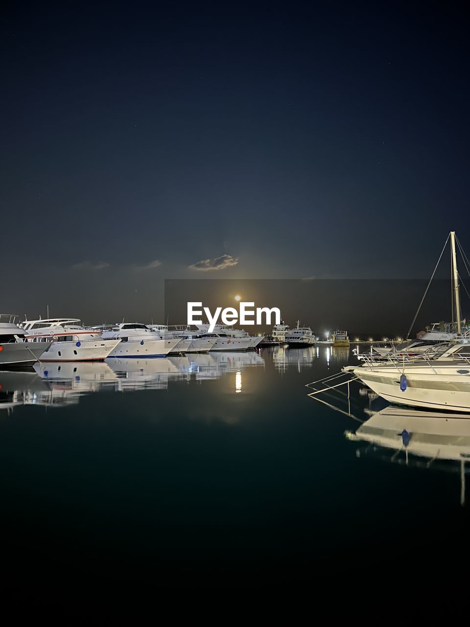 water, nautical vessel, transportation, marina, sea, sky, mode of transportation, dock, harbor, ship, reflection, night, moored, nature, vehicle, no people, copy space, architecture, pier, travel, beauty in nature, boat, sailboat, tranquility, travel destinations, dusk, scenics - nature, outdoors, yacht, horizon, illuminated, tranquil scene, watercraft, city, building exterior, built structure