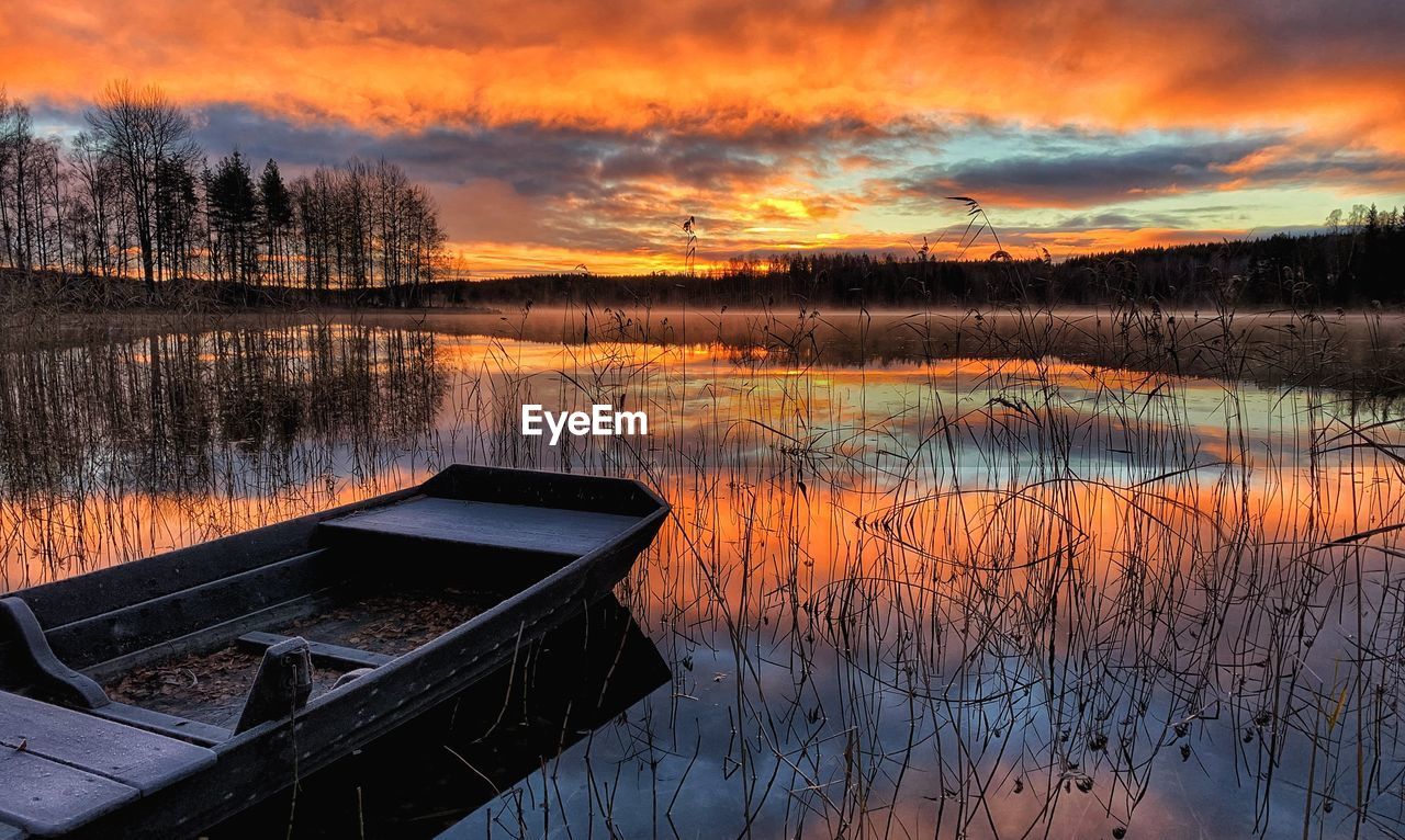 Scenic view of lake against orange sky