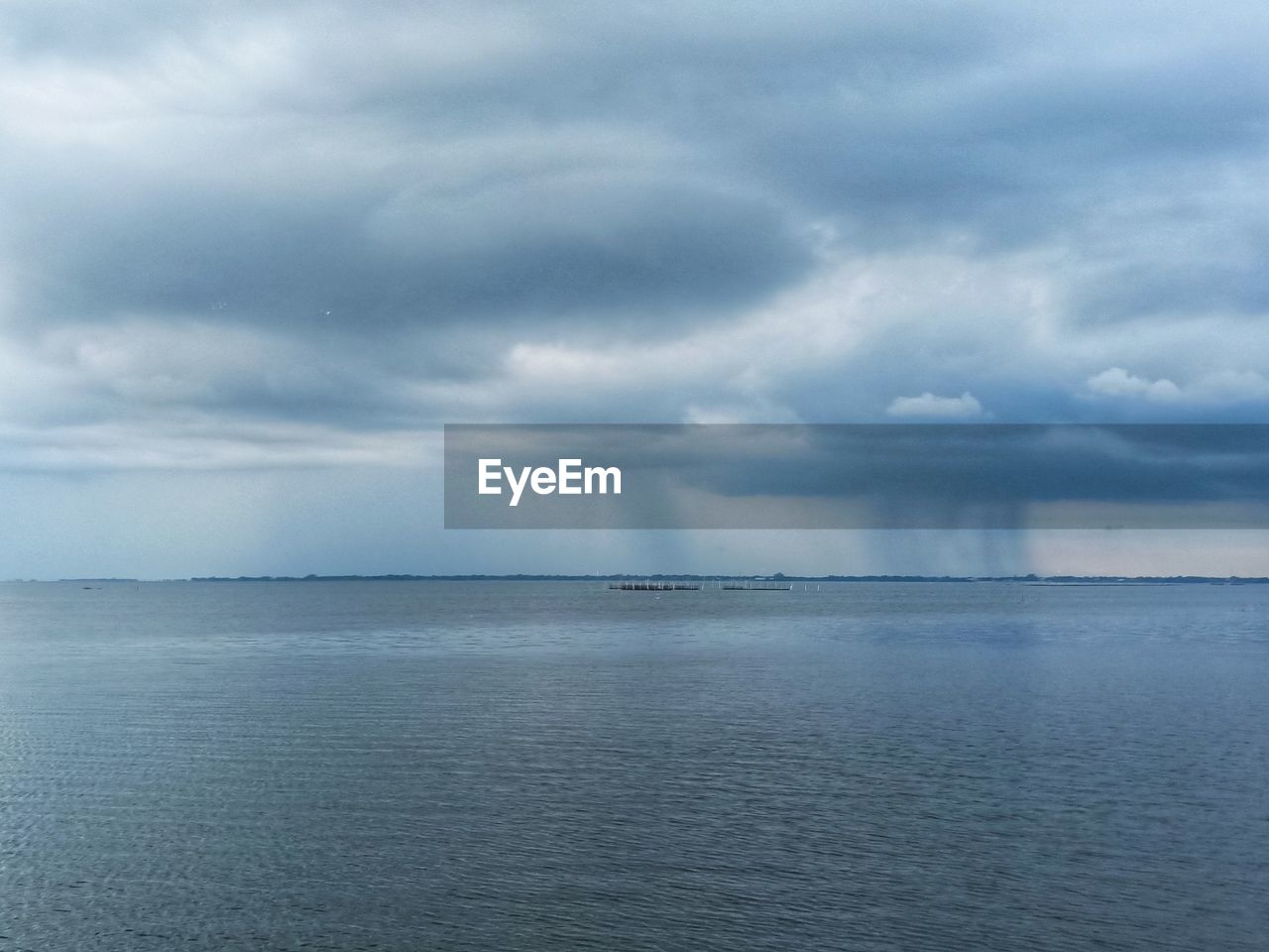 VIEW OF SEA AGAINST CLOUDY SKY