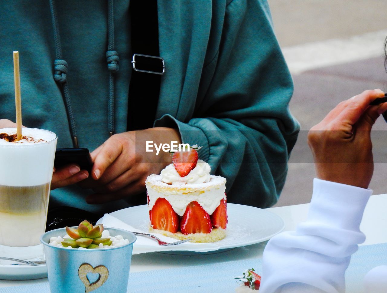 Midsection of woman having food on table