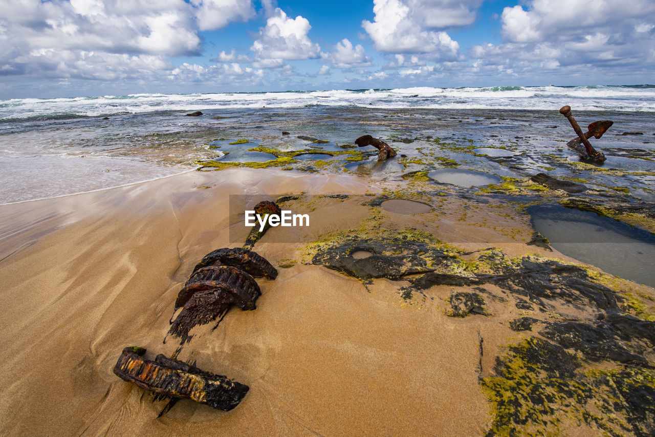 Debris of stranded ship scattered on wreck beach at victoria