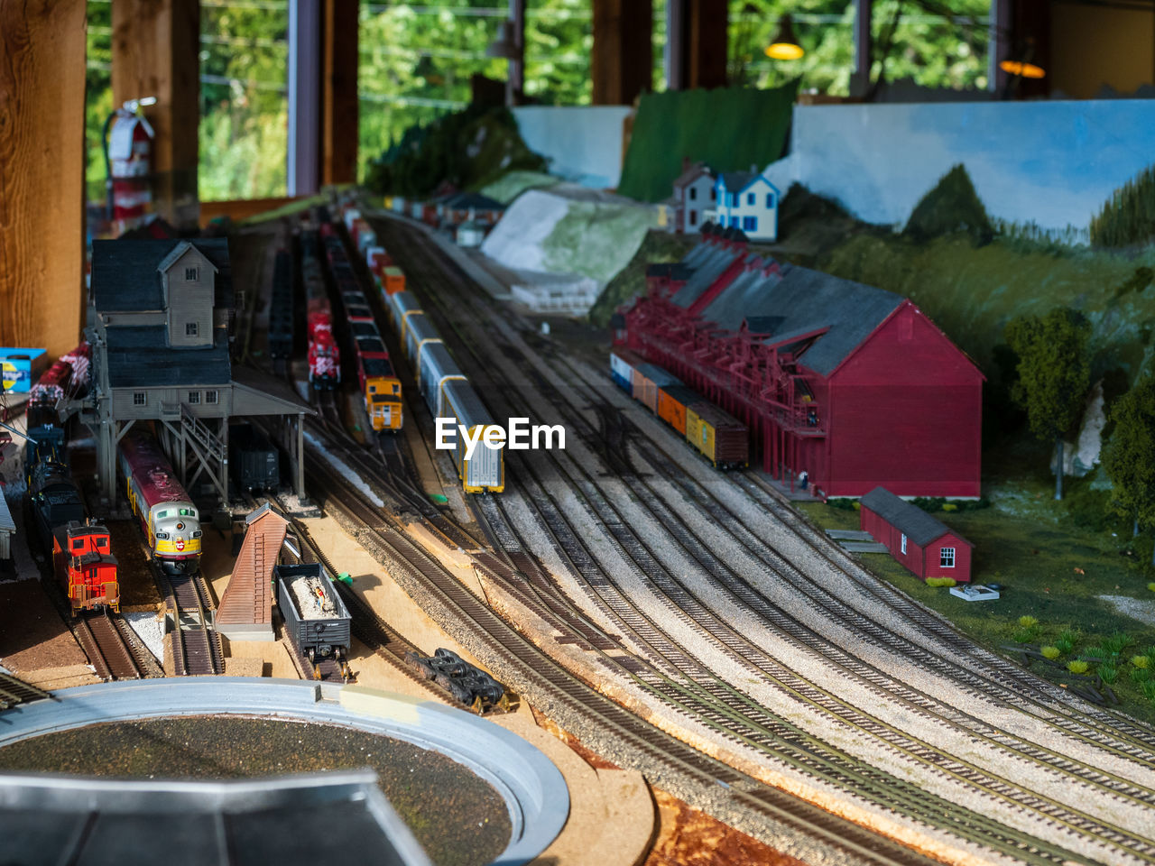 train, transportation, architecture, mode of transportation, screenshot, transport, vehicle, high angle view, tree, city, built structure, no people, motor vehicle, car, day, outdoors, nature, road, travel, street, rail transportation, track, plant, railroad track, building exterior