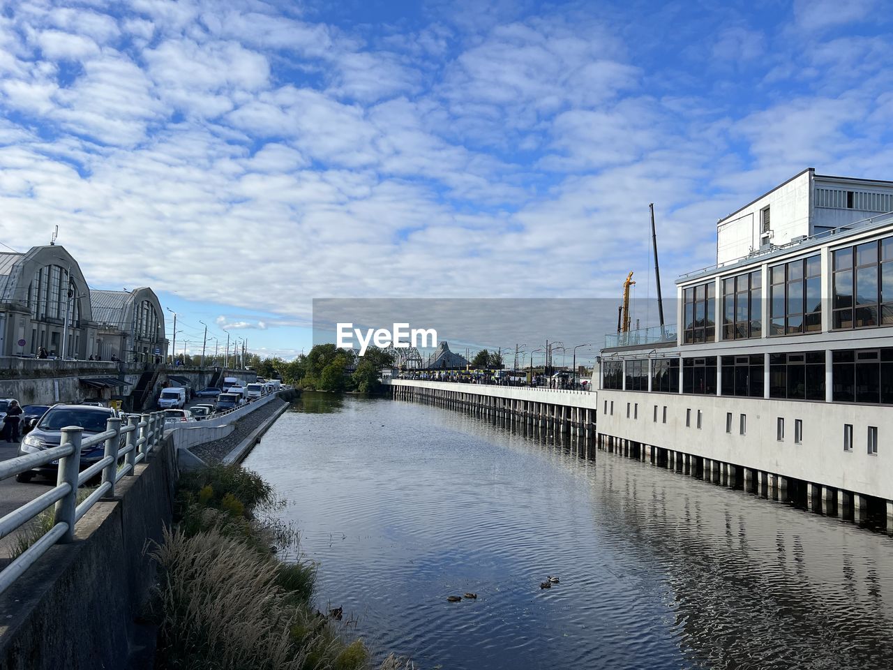 architecture, built structure, water, sky, river, reflection, cloud, building exterior, waterway, nature, city, cityscape, travel destinations, transportation, bridge, travel, no people, building, day, tourism, landmark, outdoors, nautical vessel, blue, urban area, mode of transportation, dock, vehicle, body of water