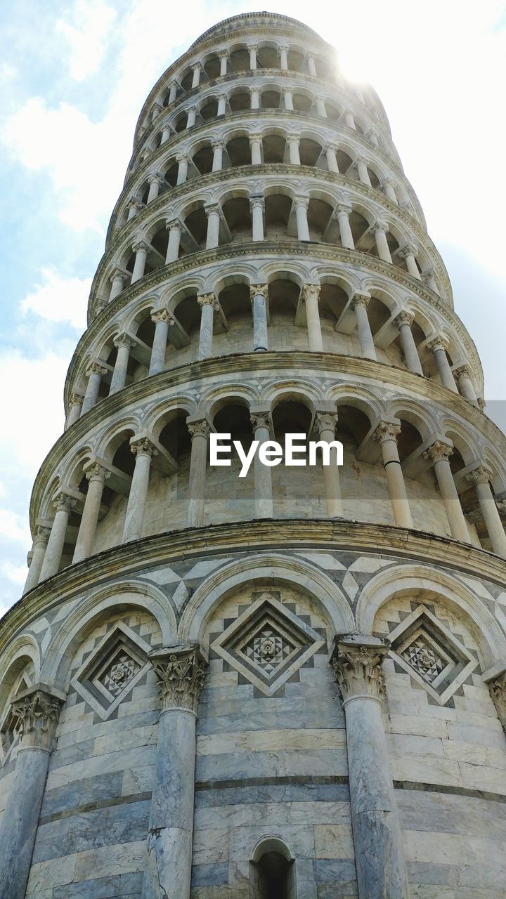 Low angle view of the leaning tower of pisa against sky