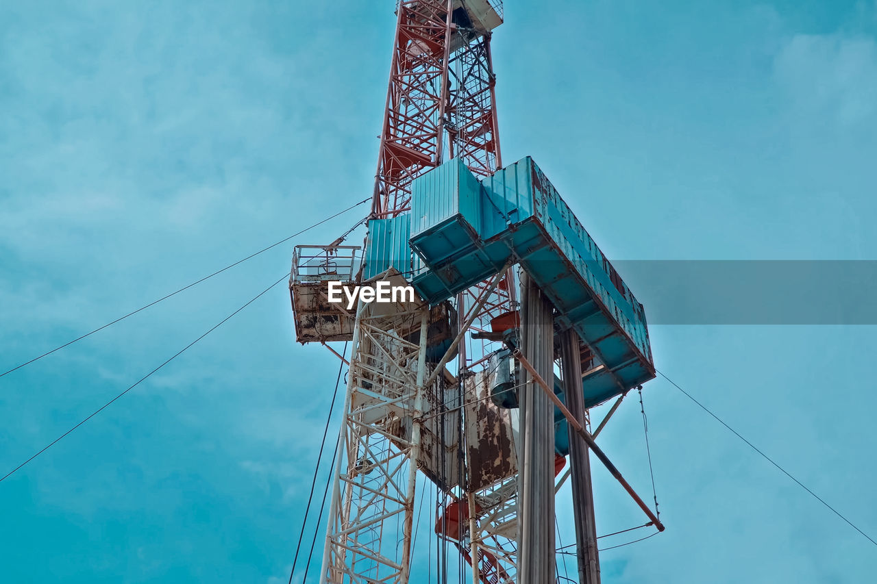 Low angle view of tower against blue sky