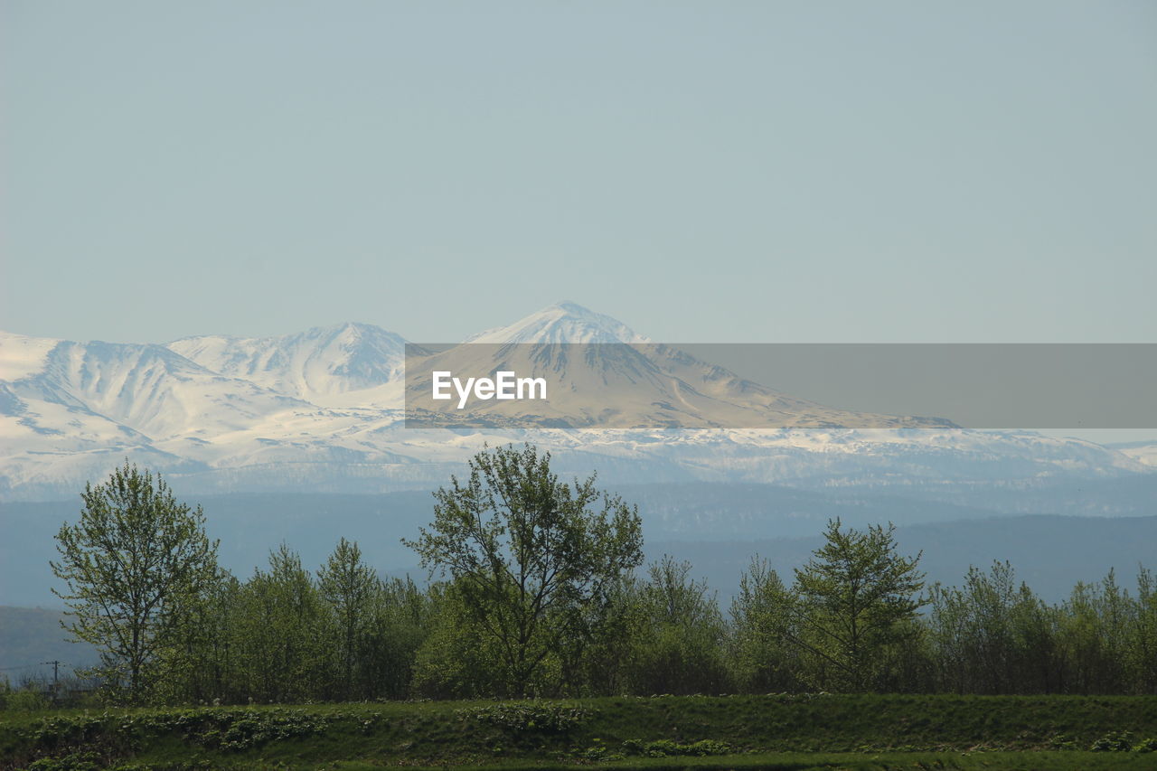 Scenic view of snowcapped mountains against clear sky