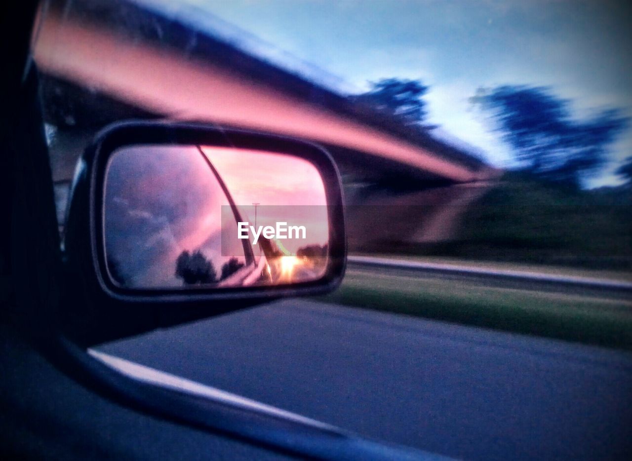 REFLECTION OF SIDE-VIEW MIRROR ON CAR