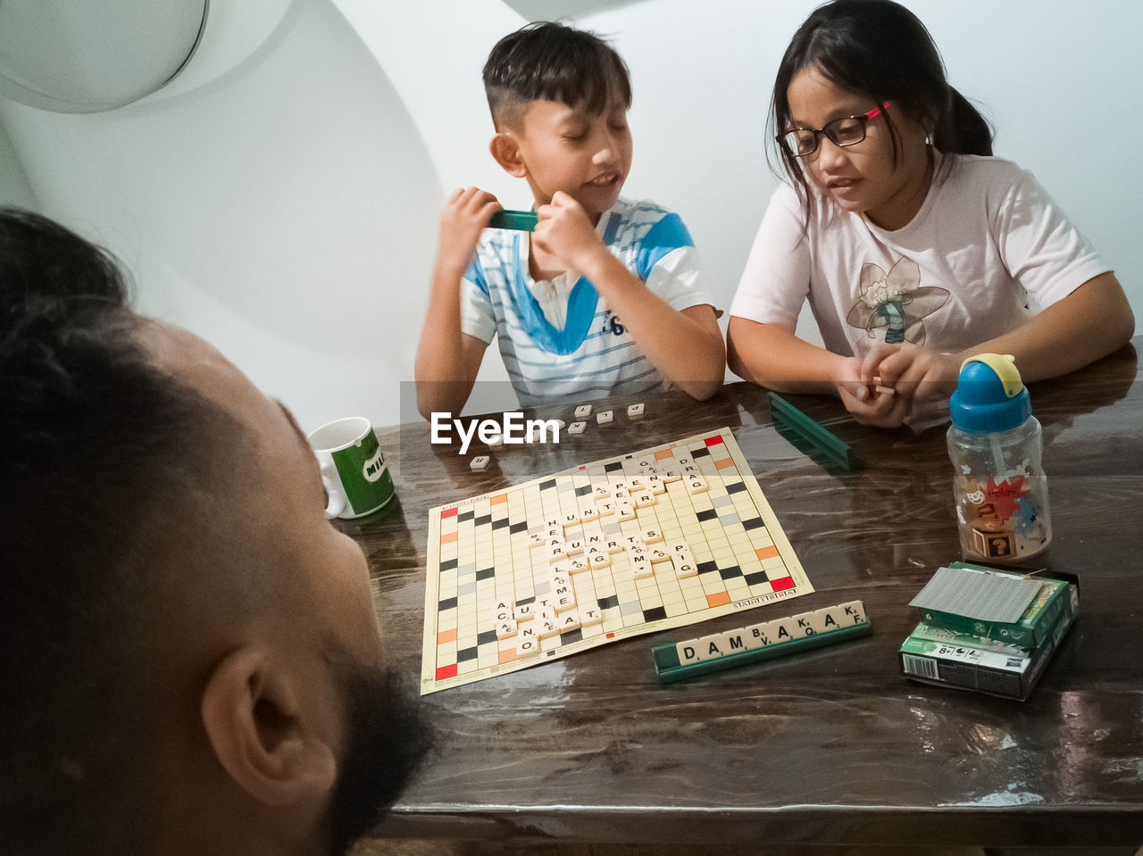 PORTRAIT OF SIBLINGS LOOKING AT CAMERA