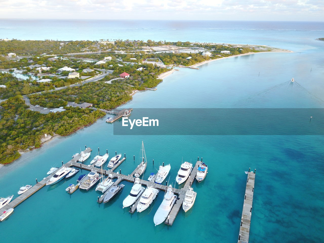 High angle view of yachts moored at harbor by city