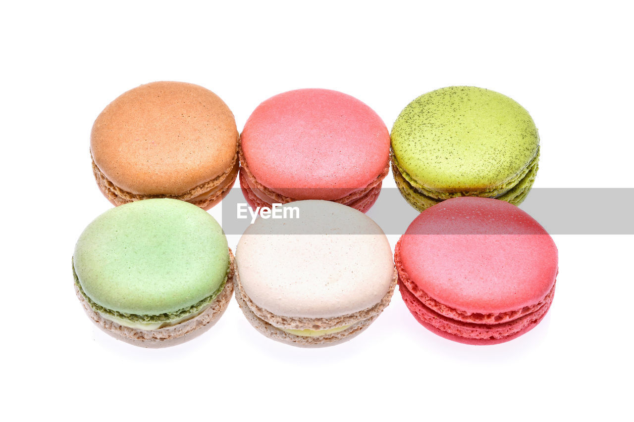 Close-up of colorful macaroons over white background