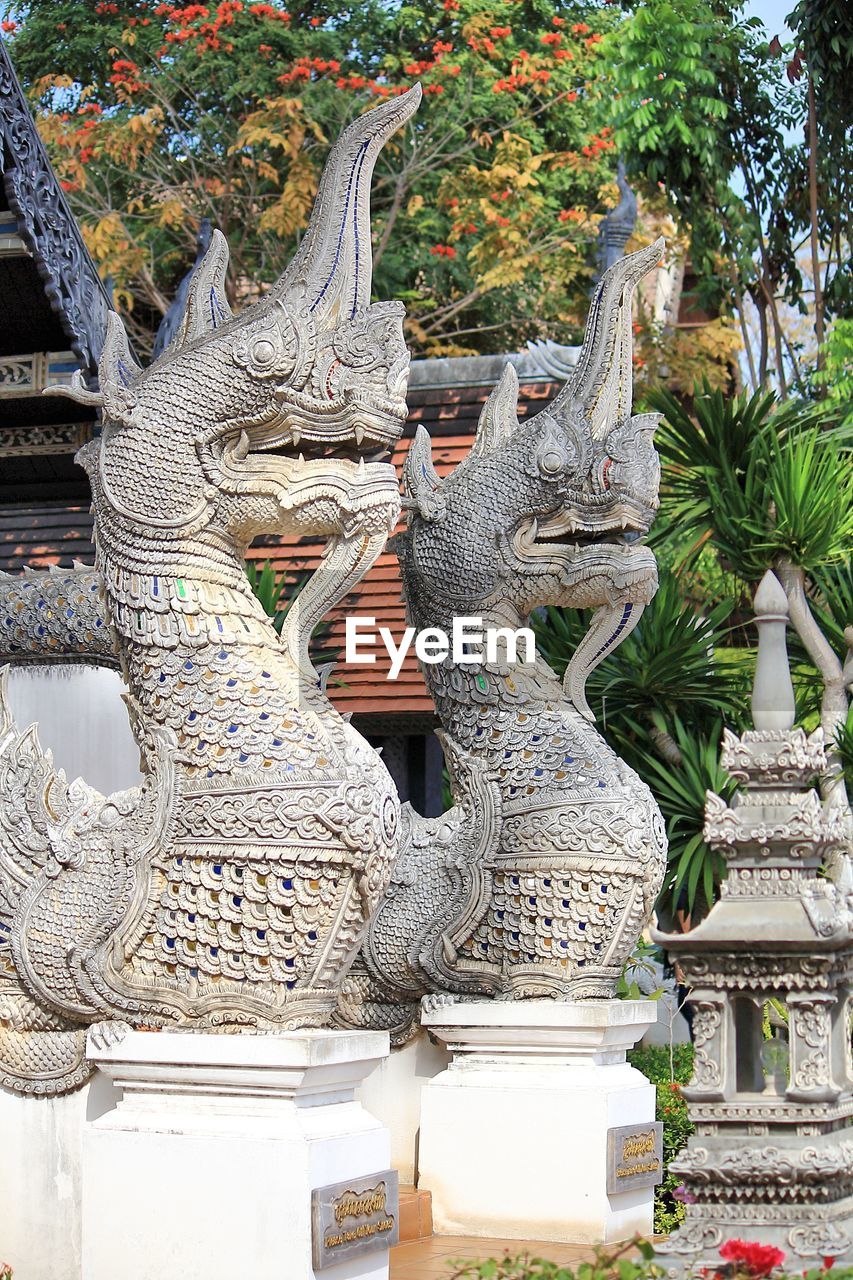 Low angle view of dragon statues in thai temple