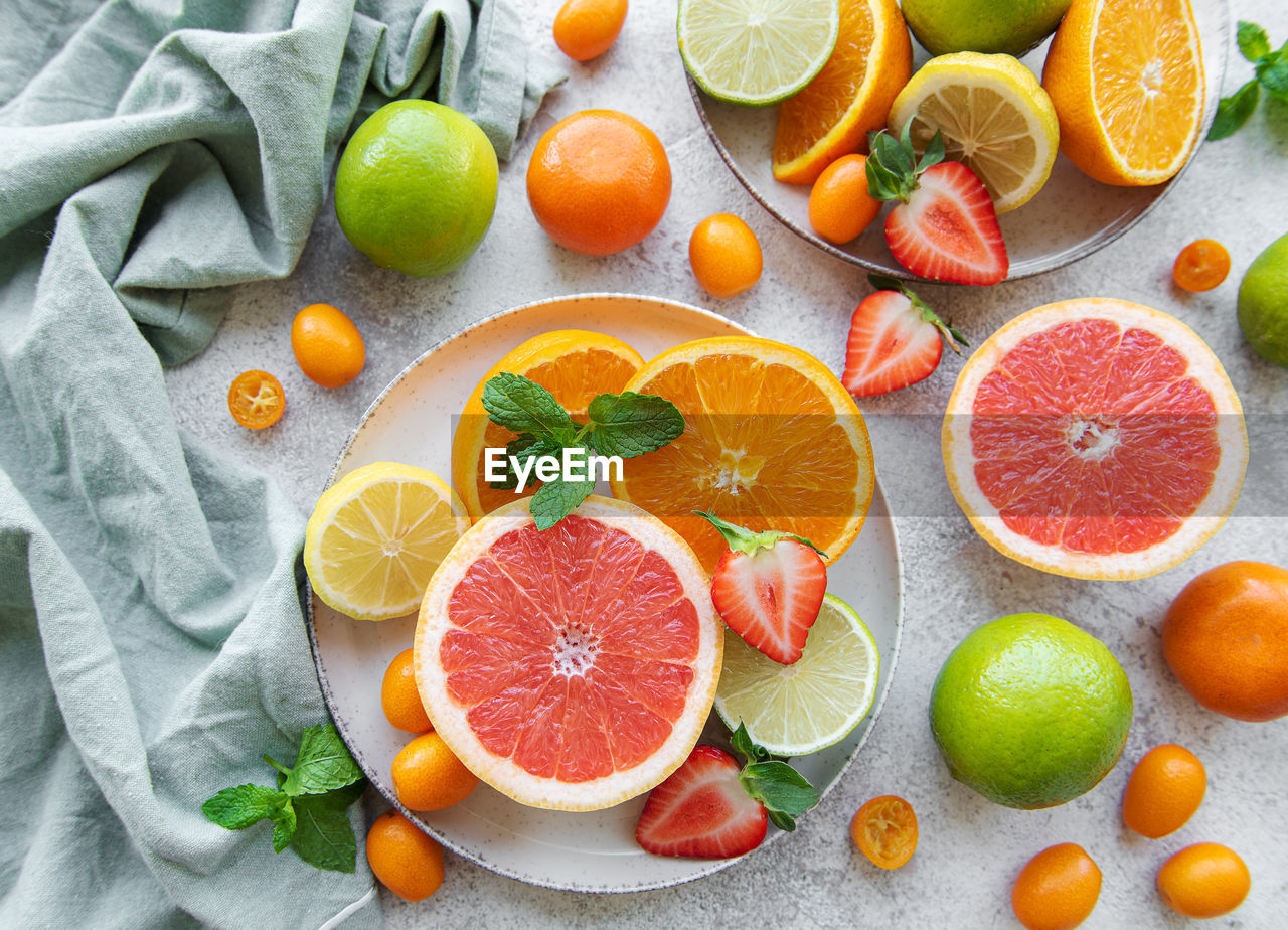 Sliced fresh summer fruits on a wooden table