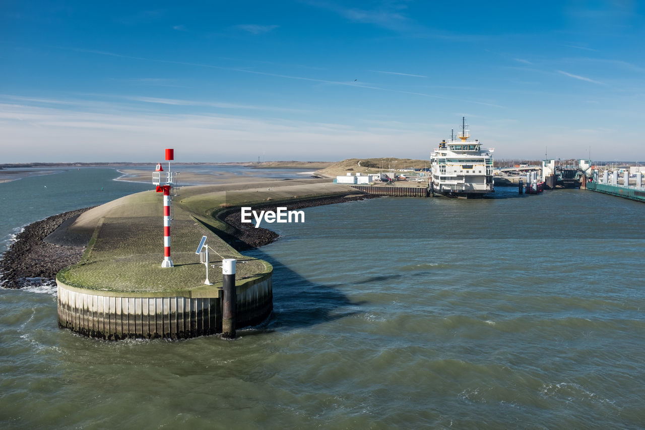 Ferry terminal on the dutch tourist island texel against blue sky