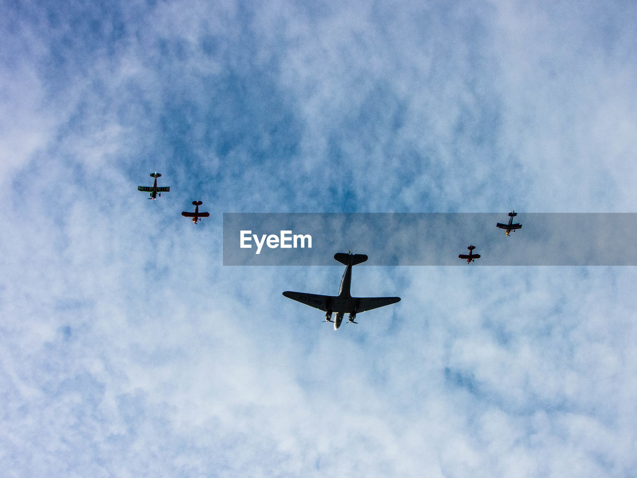Low angle view of airplanes flying against sky