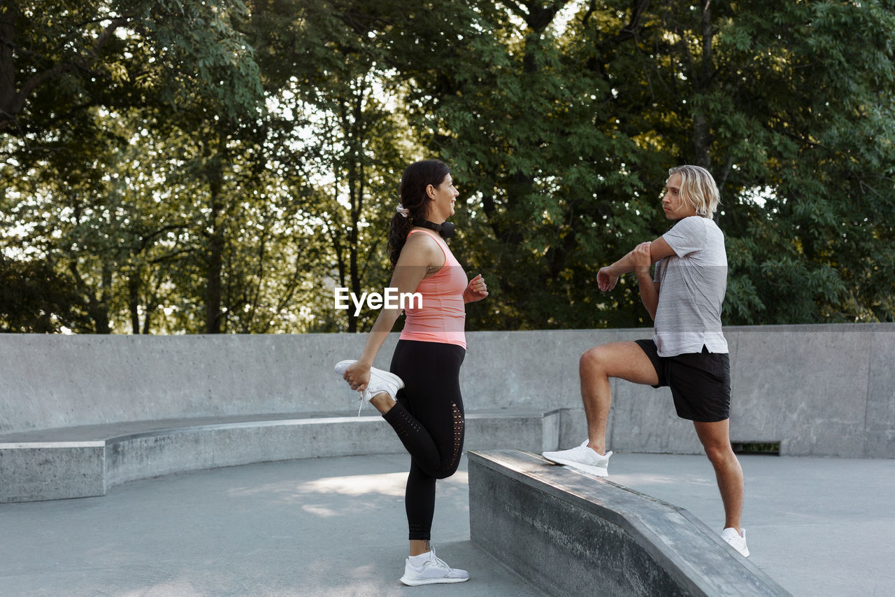 Couple exercising at skate park