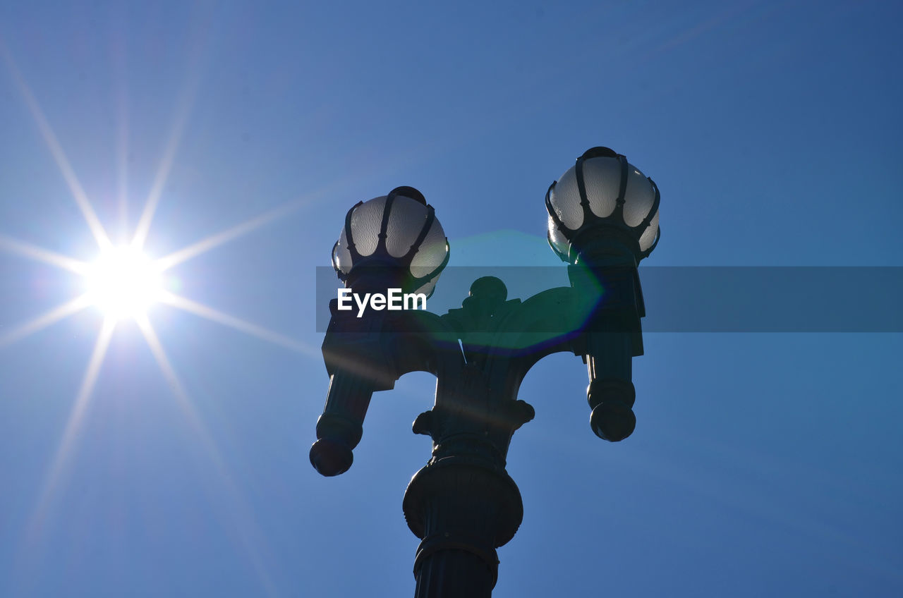 Low angle view of lamp post during sunny day