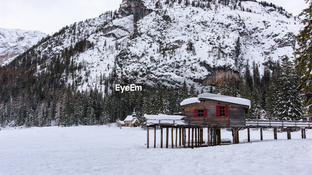 BUILT STRUCTURE ON SNOW COVERED LANDSCAPE