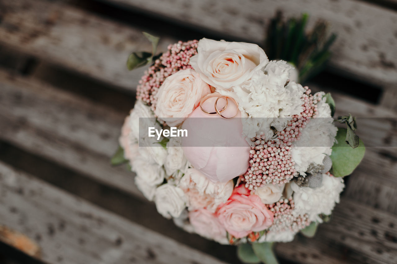flower, pink, bouquet, flowering plant, white, plant, spring, close-up, wood, floristry, wedding, no people, freshness, nature, celebration, petal, beauty in nature, floral design, food and drink, rose, decoration, indoors, focus on foreground, event, tradition, red, life events, food