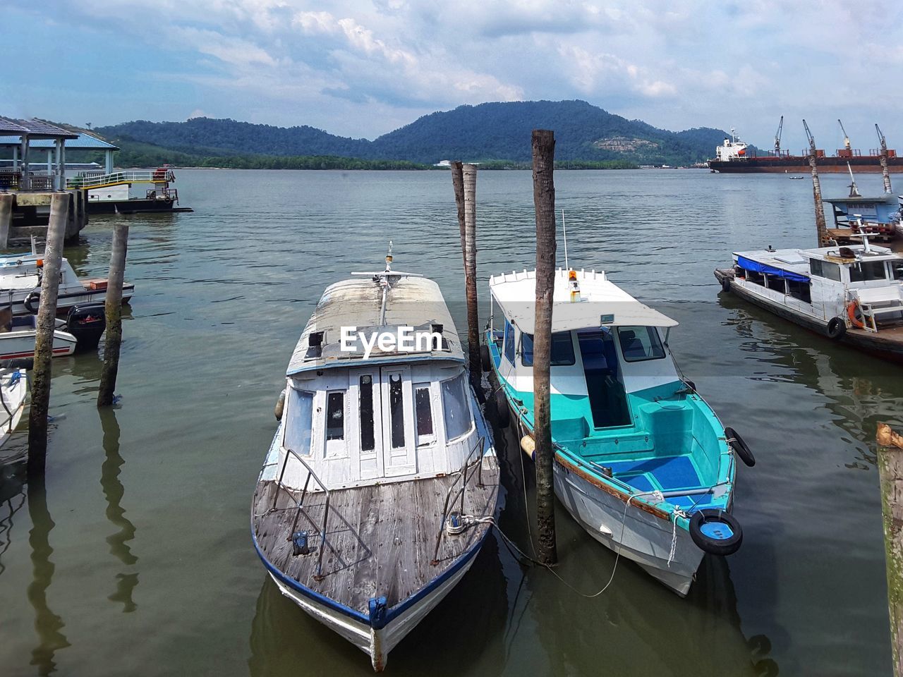 Boats moored in sea against sky