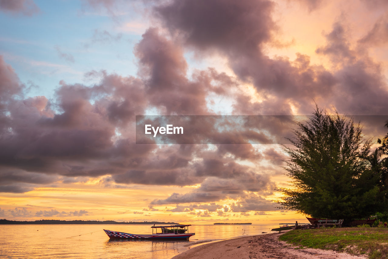 sky, cloud, water, sunset, nature, beauty in nature, transportation, nautical vessel, scenics - nature, dusk, horizon, sea, tree, environment, land, shore, evening, mode of transportation, dramatic sky, landscape, plant, travel, tranquility, no people, travel destinations, beach, afterglow, coast, outdoors, sunlight, tranquil scene, cloudscape, holiday, sun, orange color, tropical climate, tourism, vacation, trip, multi colored, idyllic, seascape, reflection