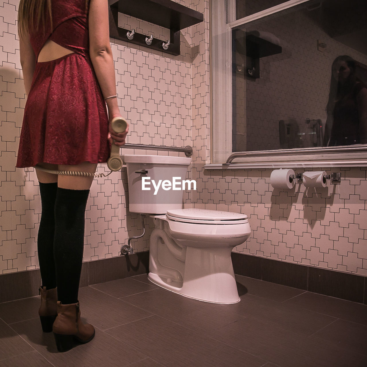 Low section of woman standing in bathroom