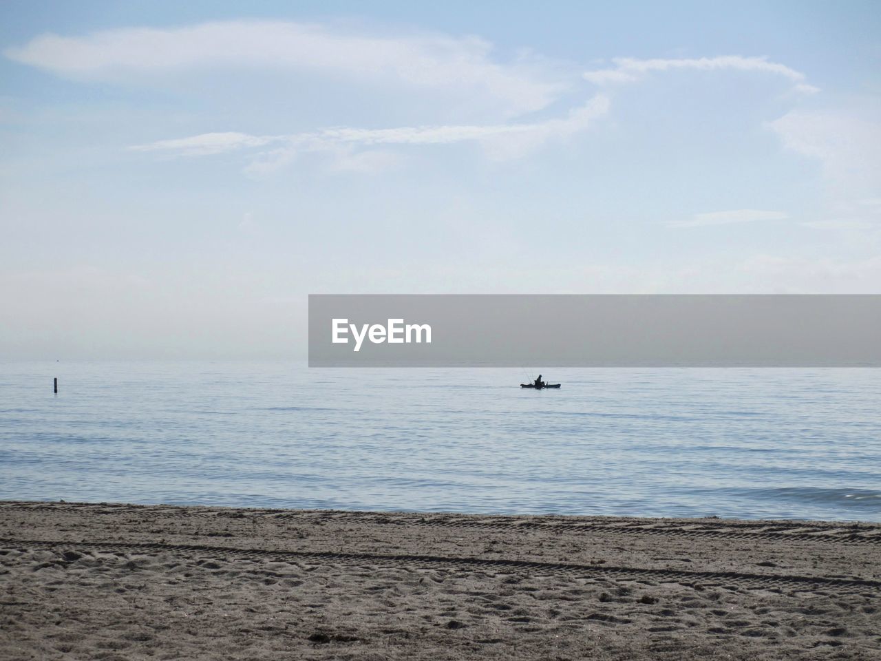 Scenic view of lone kayaker oon ocean
