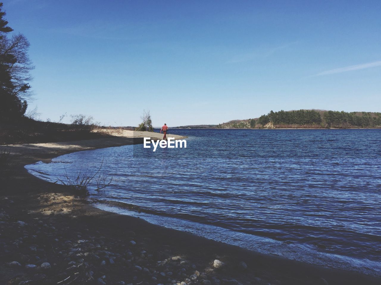 Calm lake against blue sky