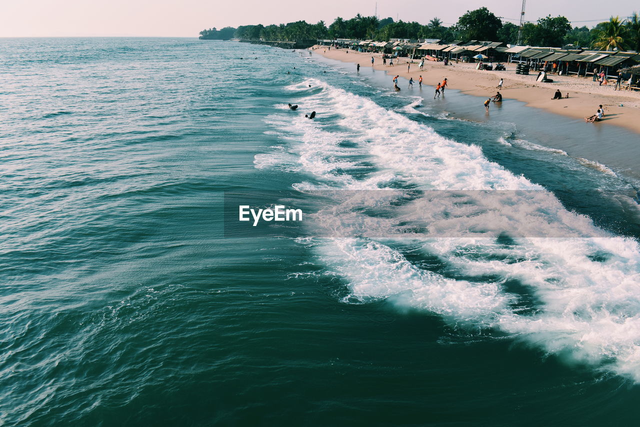 High angle view of people enjoying at beach