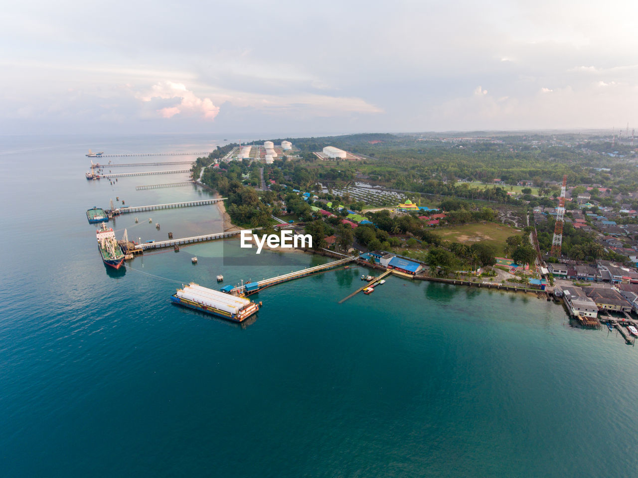 High angle view of cityscape by sea against sky