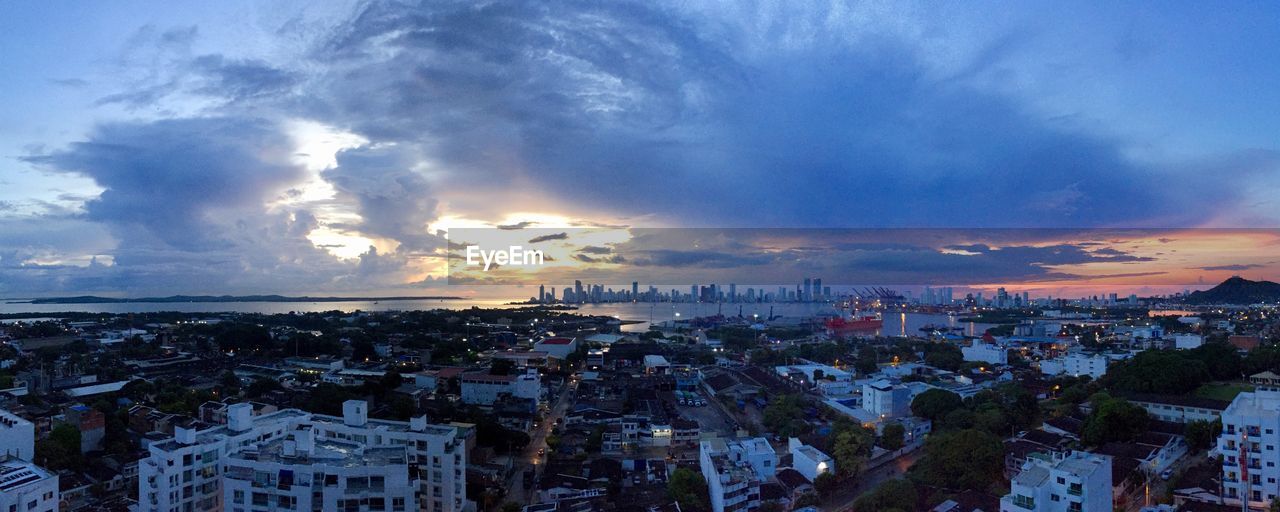 HIGH ANGLE SHOT OF TOWNSCAPE AGAINST SKY DURING SUNSET