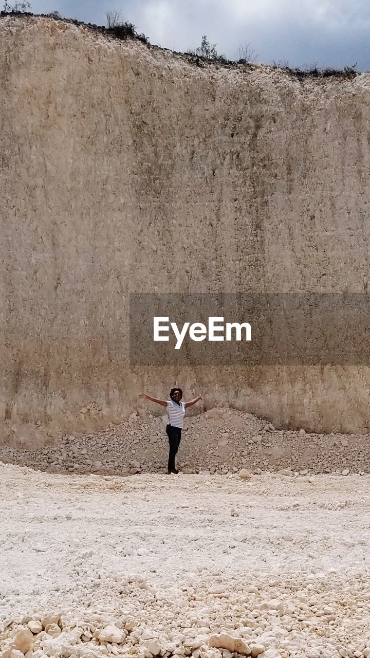 Woman standing in limestone quarry 