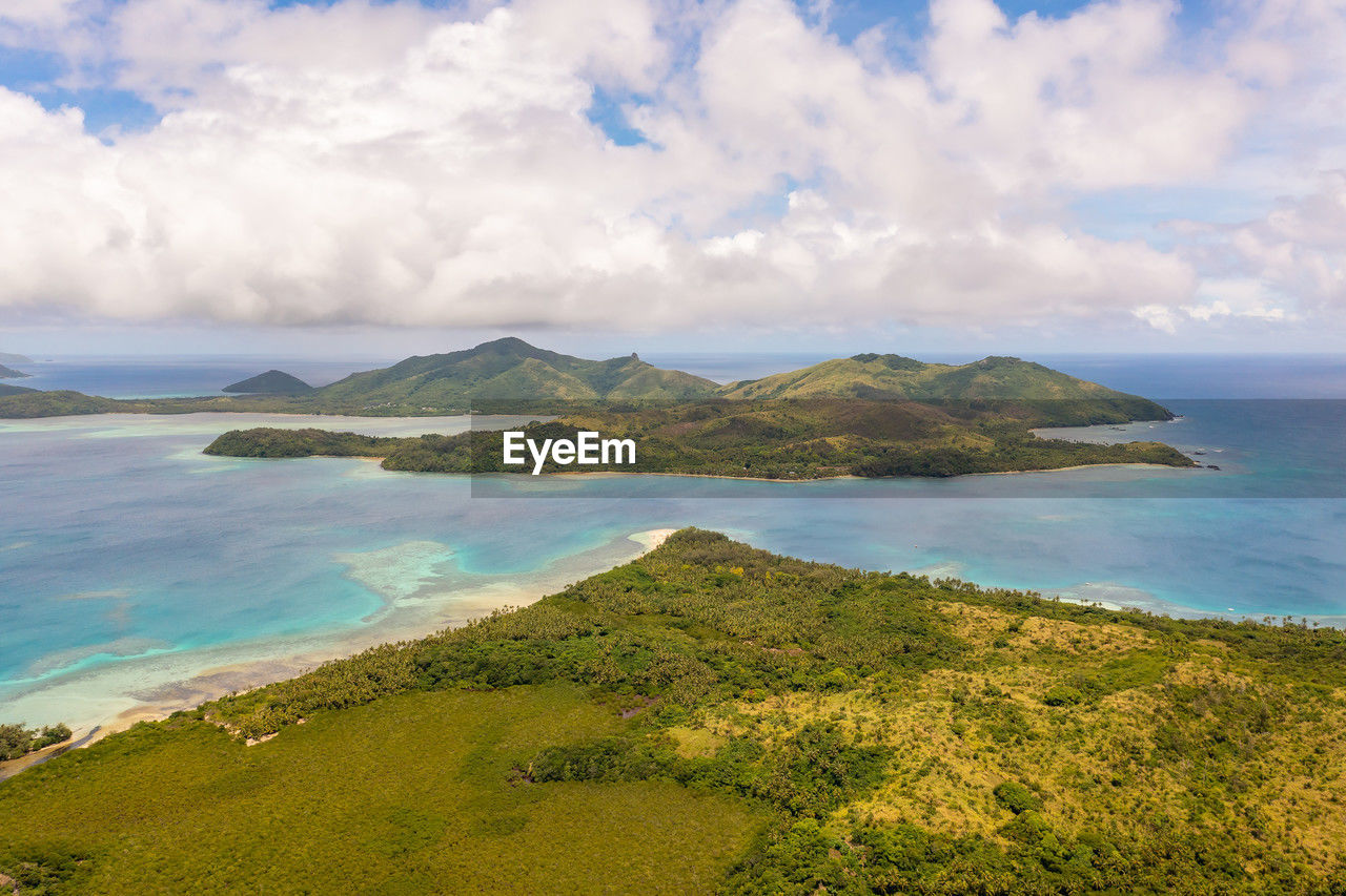 Drone view of green tropical forests. cumulus clouds over fiji islands. vacation and travel concept