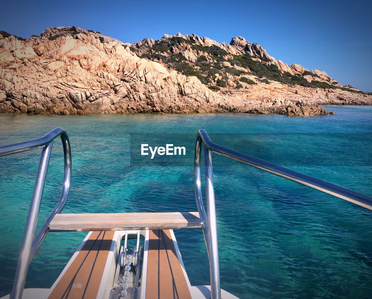 Scenic view of sea and mountains against blue sky