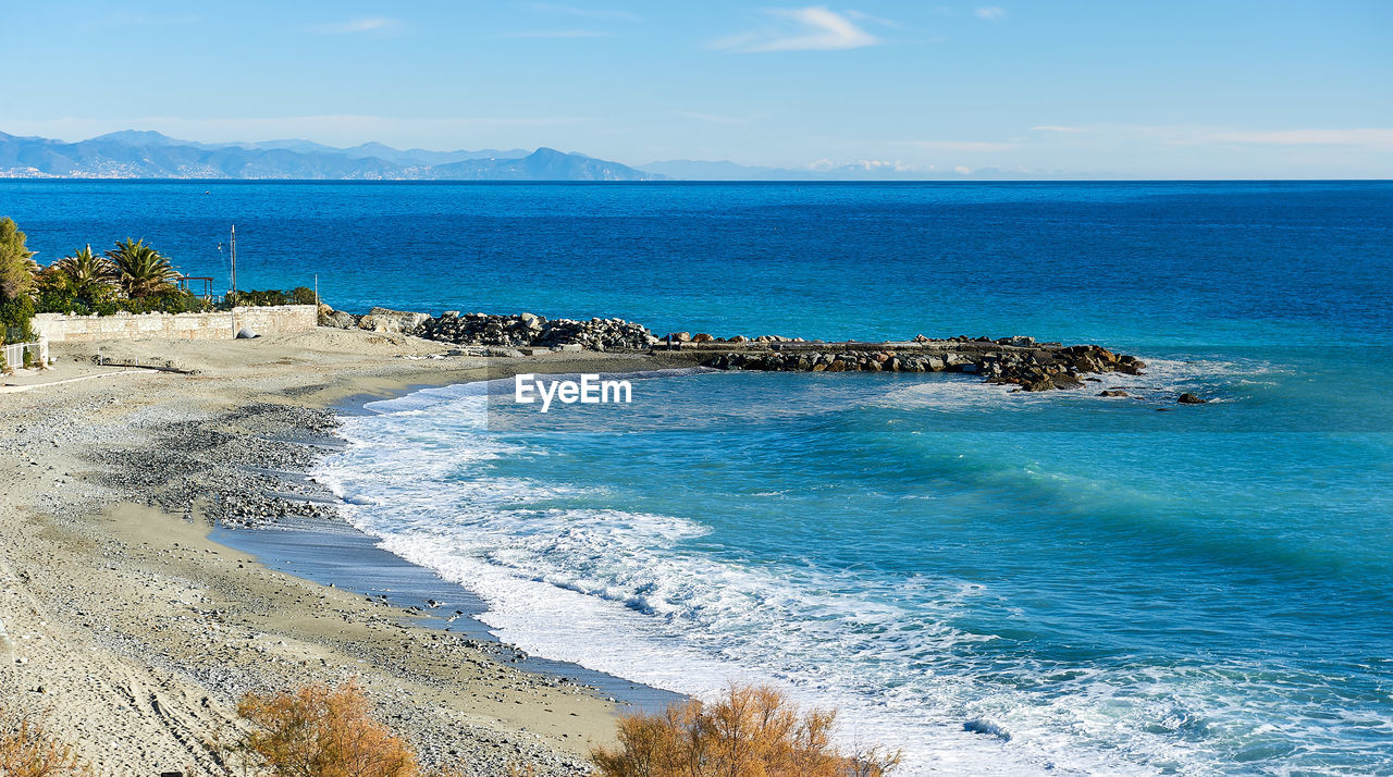 Scenic view of sea against blue sky