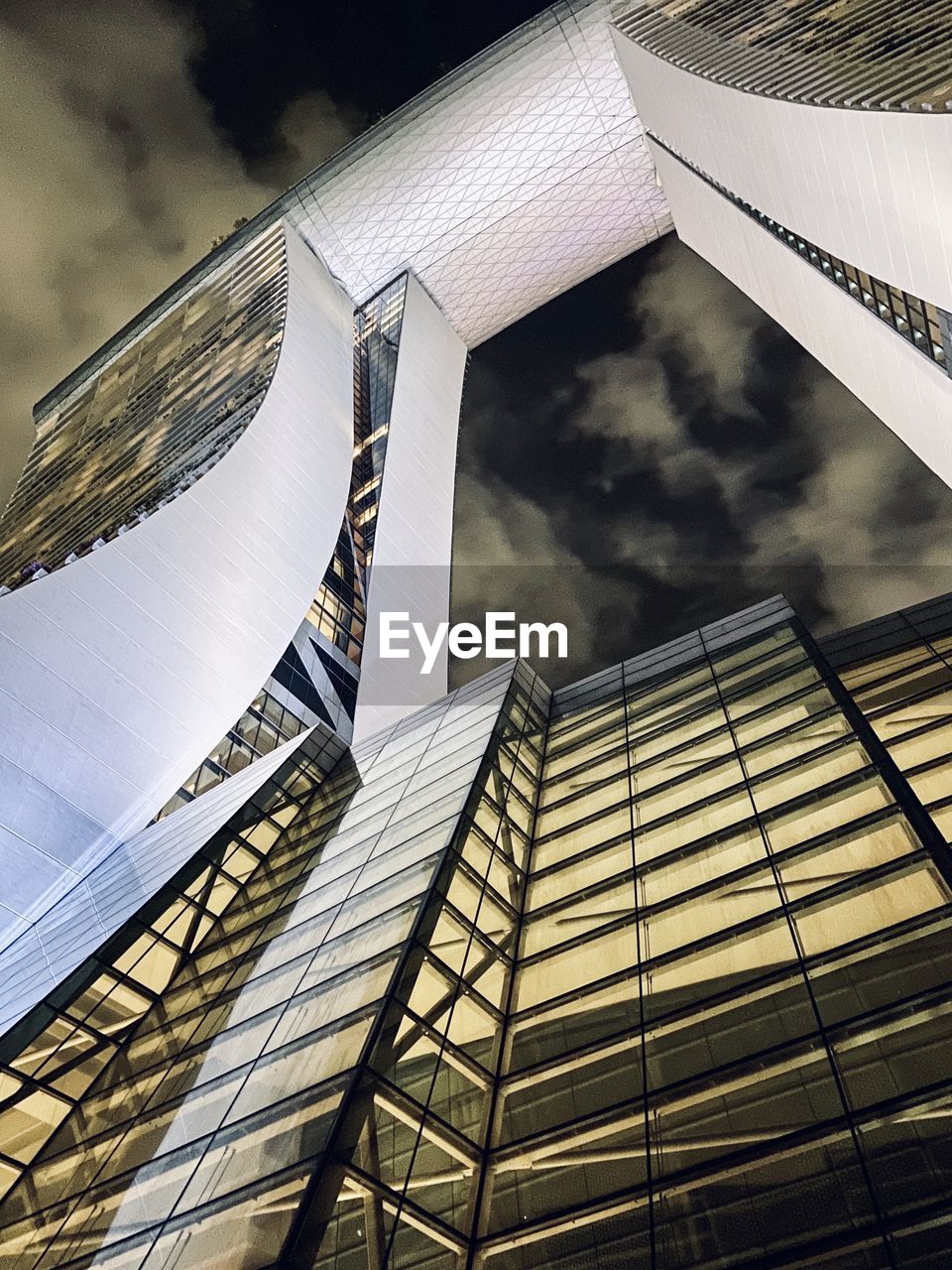 DIRECTLY BELOW SHOT OF MODERN BUILDINGS AGAINST SKY