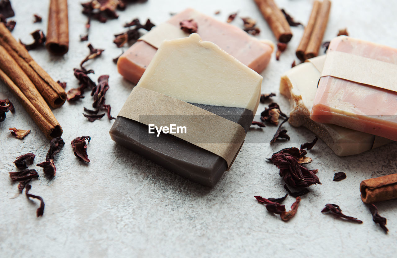 Spa setting witn natural handmade soap with cinnamon and flower petals