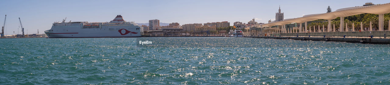 BUILDINGS AT WATERFRONT AGAINST SKY