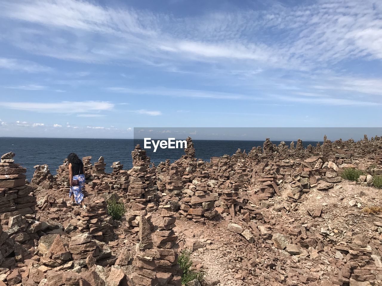 sky, sea, water, land, nature, coast, shore, beach, rock, cloud, scenics - nature, horizon over water, cliff, terrain, horizon, ocean, environment, travel, beauty in nature, travel destinations, landscape, day, holiday, outdoors, blue, body of water, group of people, vacation, trip, geology, tourism, tranquility, coastline, sand, tranquil scene, bay