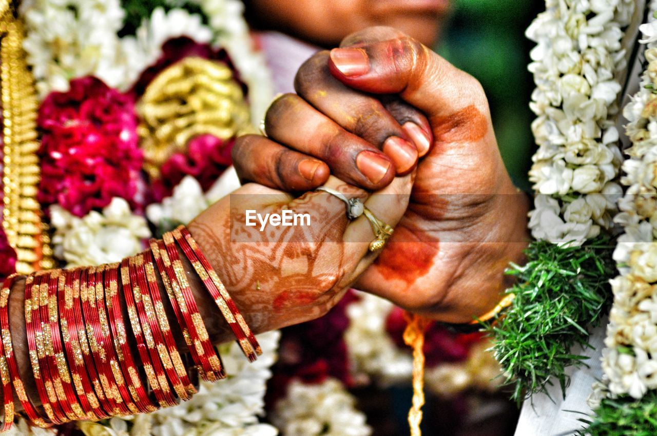 Close-up of couple holding hands