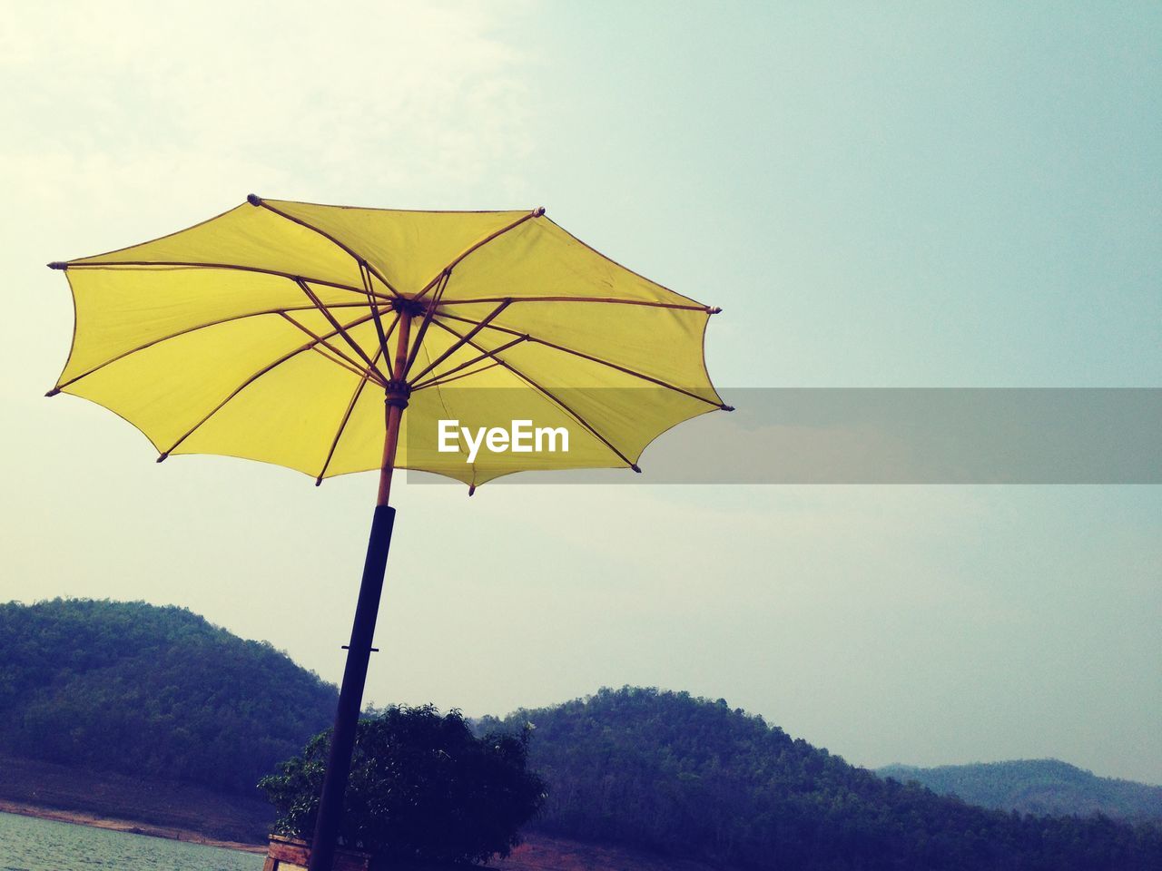 Low angle view of parasol against sky