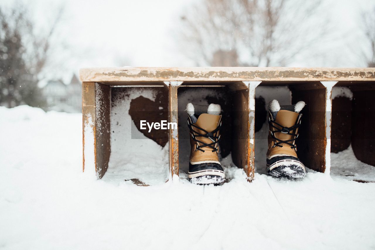 Frozen shoes in shelf during winter