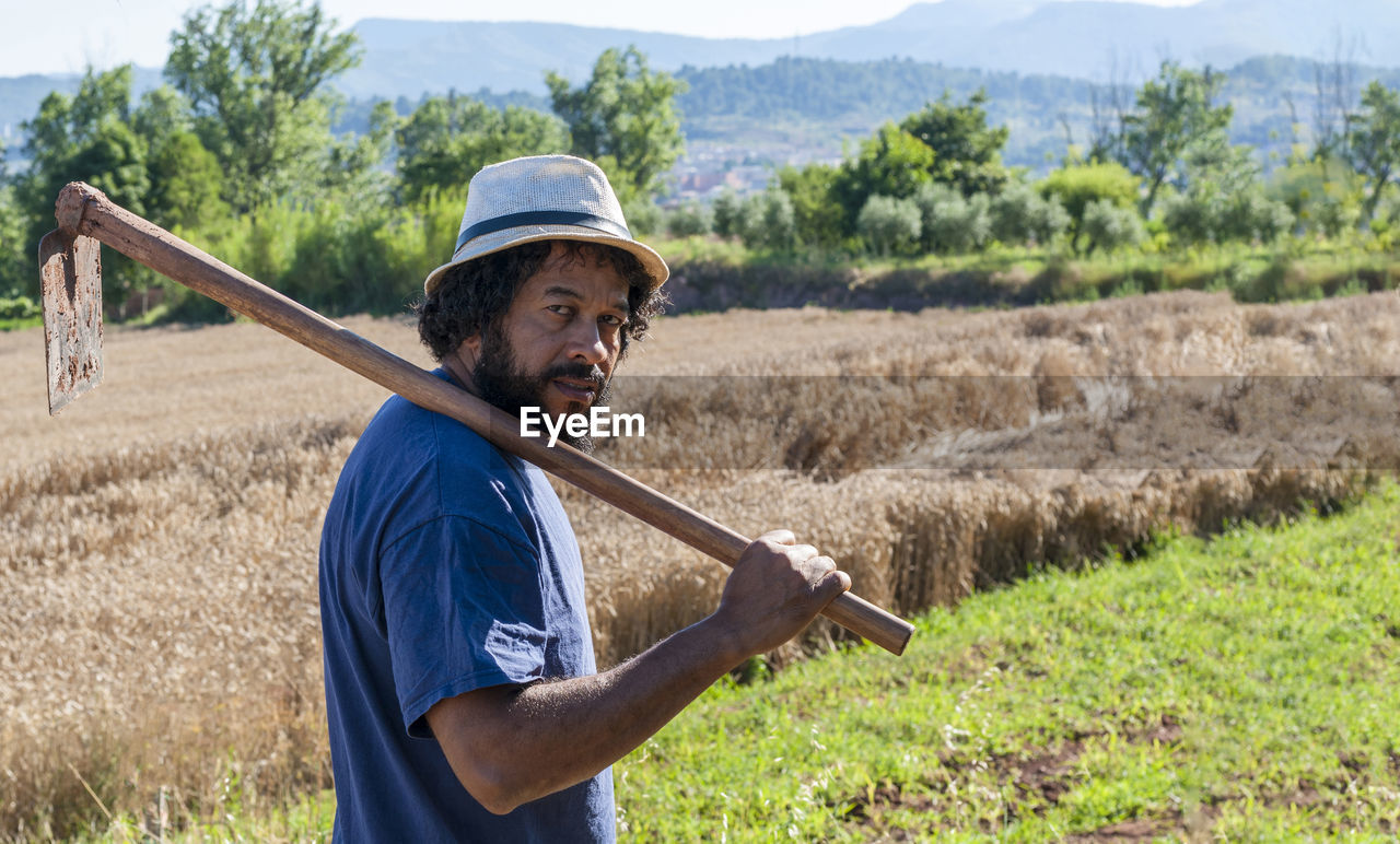 Colombian portrait with an orchard tool, copy space.