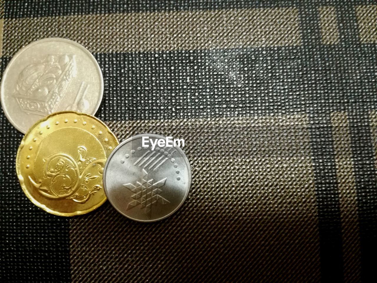 CLOSE-UP OF COINS ON TABLE