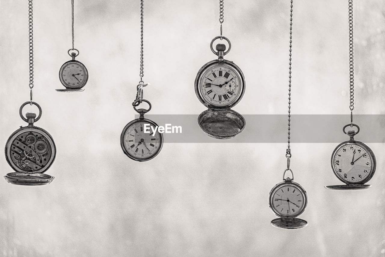 Close-up of pocket watches hanging side by side