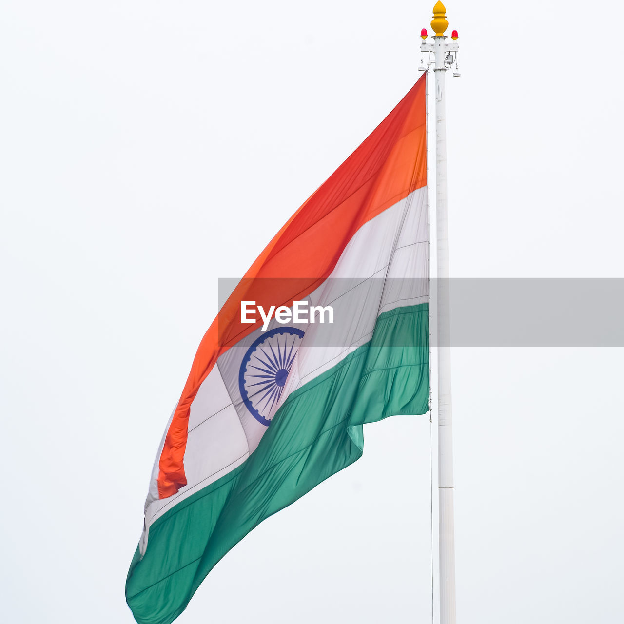 flag, patriotism, wind, environment, nature, no people, pole, low angle view, red, sky, pride, copy space, day, outdoors