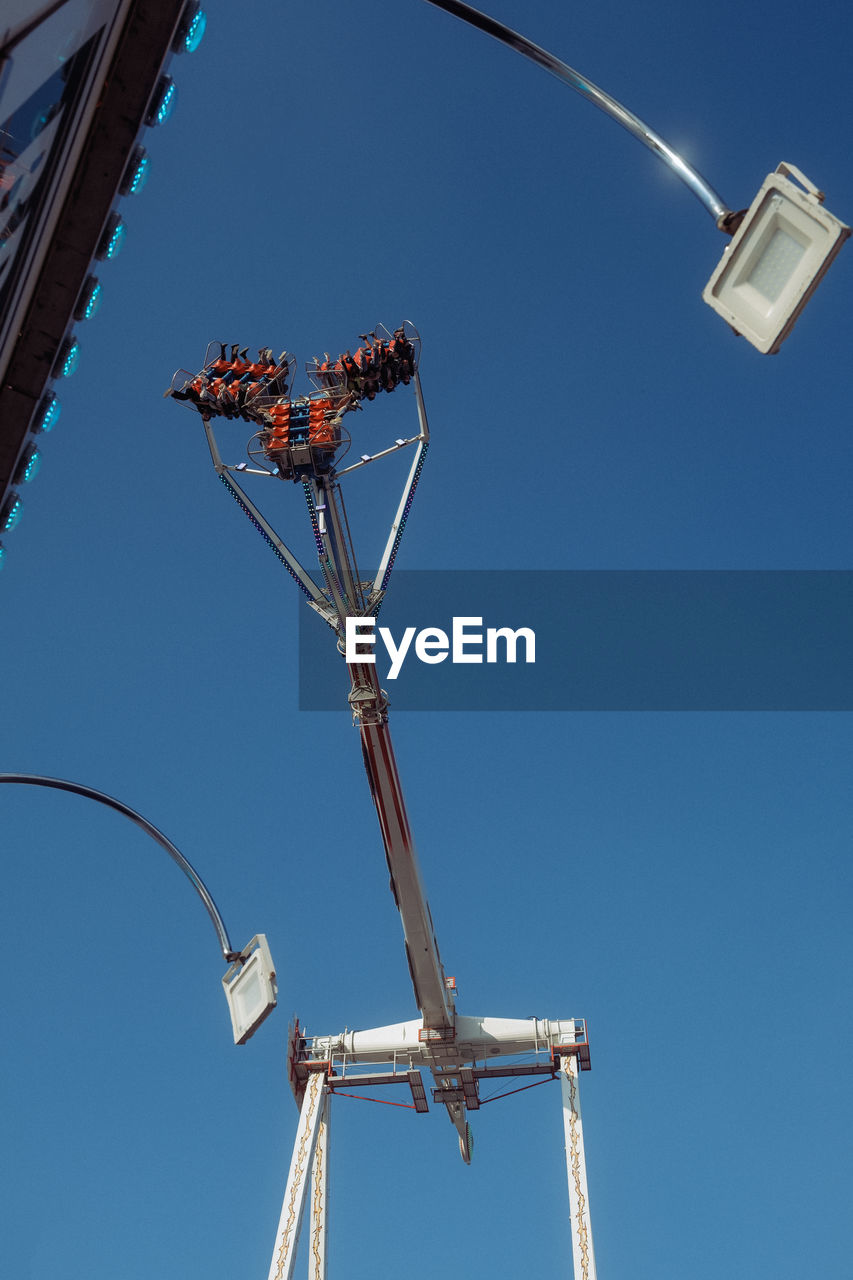 sky, blue, clear sky, low angle view, nature, mast, electricity, sunny, day, architecture, outdoors, no people, street light, lighting, arts culture and entertainment, machinery, built structure