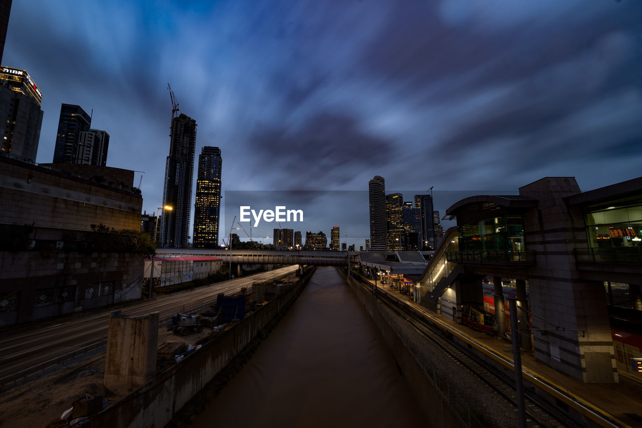 buildings in city against sky at dusk