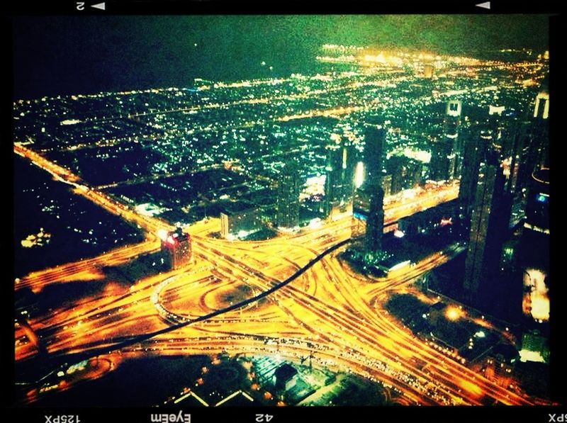 HIGH ANGLE VIEW OF ILLUMINATED CITYSCAPE AT NIGHT