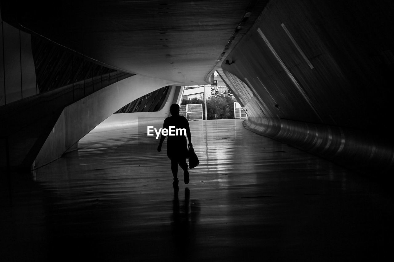 Rear view of silhouette person walking in subway